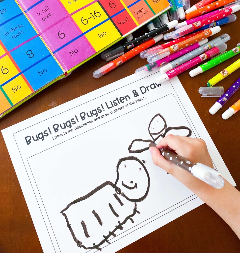 The image shows a child drawing a bug with crayon on a worksheet.